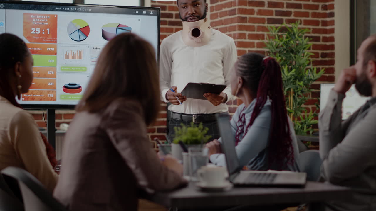 African american man with cervical neck collar doing wrok presentation