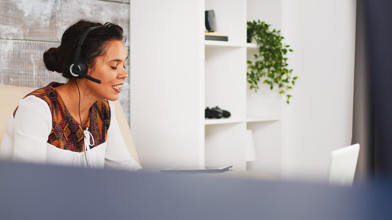 Young woman with headphones waving