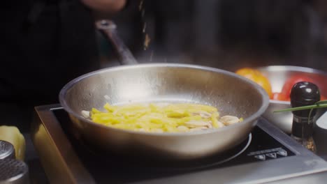 chef cooking vegetables in a pan