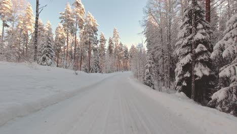 thrilling pov winter drive in scenic snow covered forest environment finland
