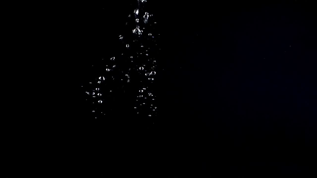 Bubbles under water on a black background. Shooting on a black background