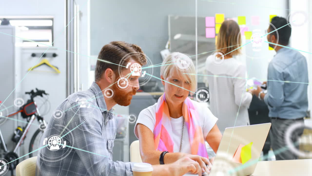 Collaborating at desk, business professionals with digital network animation overlay