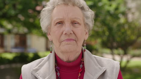 portrait-of-proud-elderly-woman-smiling-looking-serious-at-camera