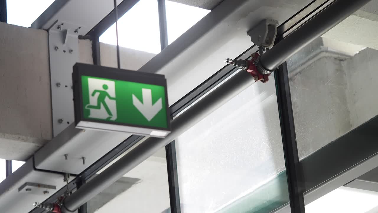 Emergency Exit Sign with Down Arrow and Person Icon