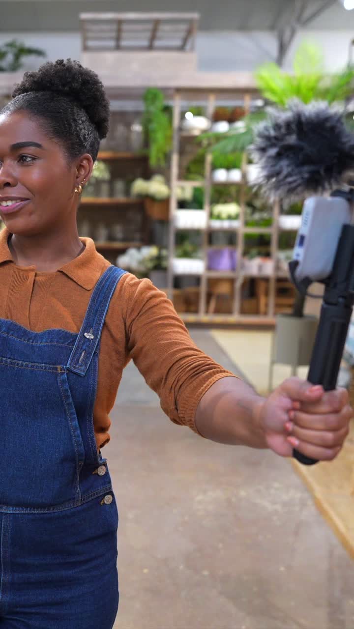 Woman vlogging in a flower shop