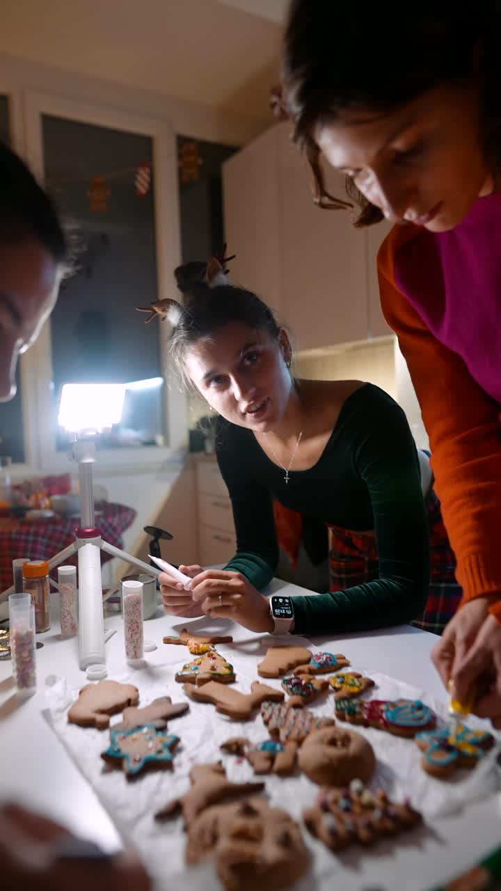 Women decorating cookies in the kitchen