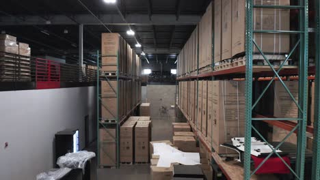 Aerial,-identical-cardboard-boxes-on-pallets-racks-in-shipping-storage-warehouse