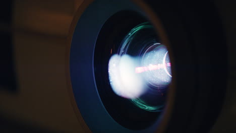 close-up-digital-projector-lense-with-light-projection-modern-multimedia-cinema-technology