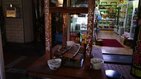 a quiet evening scene outside a cozy japanese eatery.