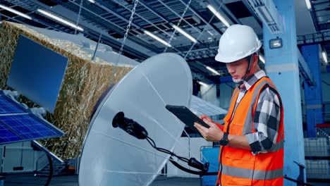 satellite technician inspecting equipment