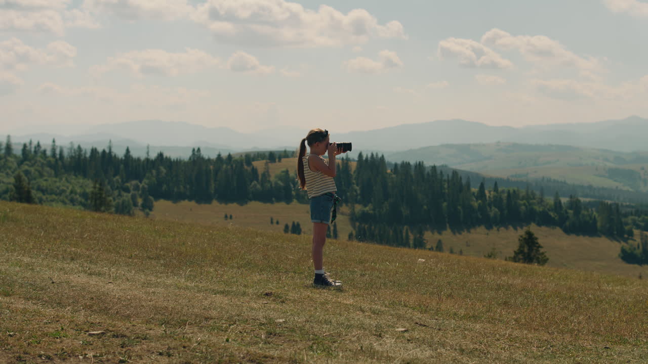 Young Girl Photographer Shooting Landscape Young Photographer Shooting Landscape on Beautifull Green Hillway Taking Pictures of Nature Girl Filling the Portfolio with Amazing Photos Spending Leisure Time Outdoor Slow Motion