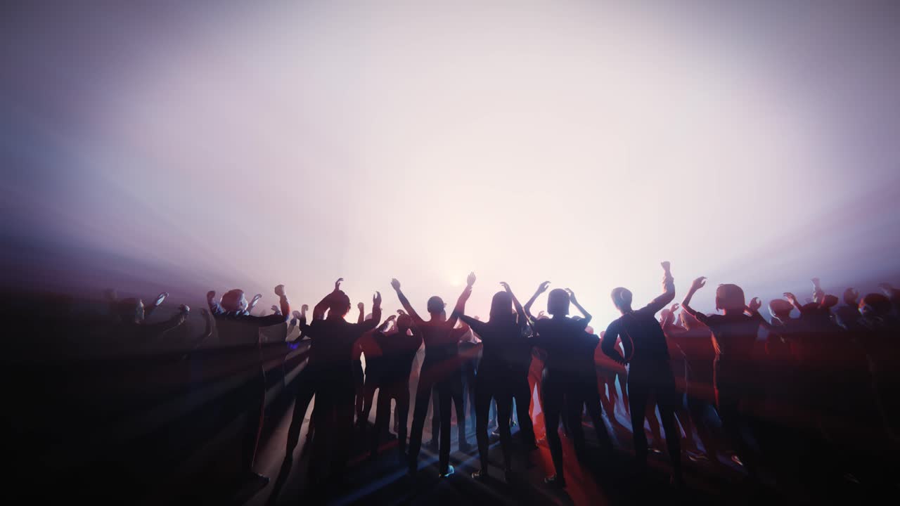 Audience Silhouettes with Hands Up in Bright Stage Light
