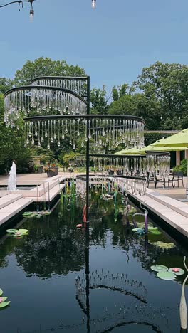 glass art installation in a garden pond