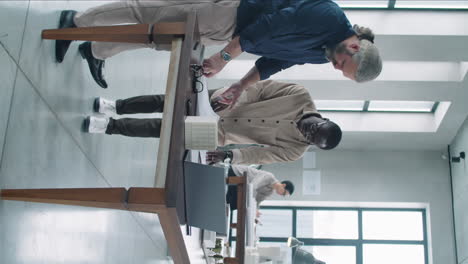 young and senior multiethnic architects discussing floor plan