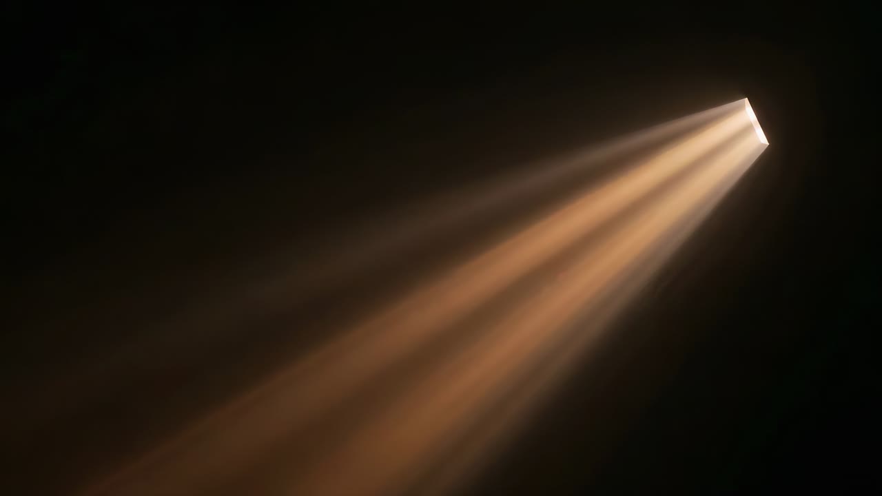 Projecting bundle of warm amber light beams from narrow slit across dark room, revealing dust haze