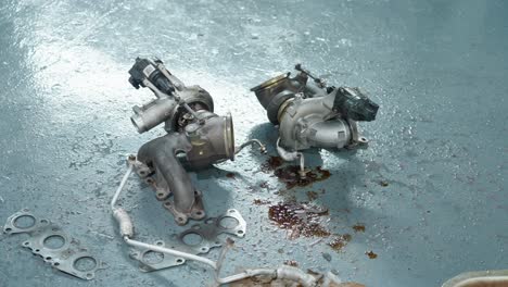 medium shot of an old car turbocharger on the floor of a garage in petaling jaya, in the state of selangor, malaysia