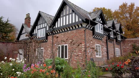 Tracking-shot-of-an-old-Tudor-house-in-walled-garden-setting