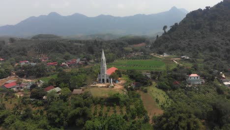 Aerial-view-of-Giáo-Xứ-Bạch-Xa-Catholic-Church-With-A-Greenery-Surrounded-Farm