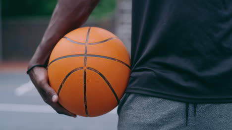 man holding basketball on court