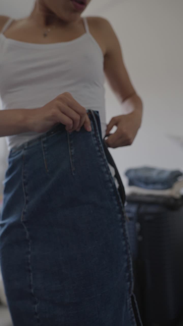 Woman trying on a denim skirt