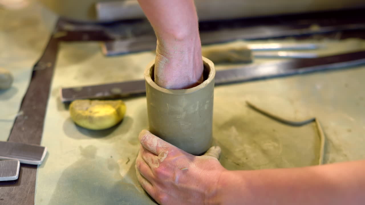 Students modelling clay into cups