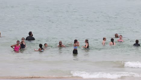 people enjoying the ocean together on a cloudy day