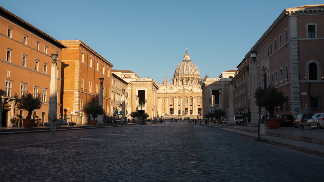 Sun rise view of basilica dome at the Vatican, time lapse of streets becoming busy as light spills on this Roman Catholic scene.