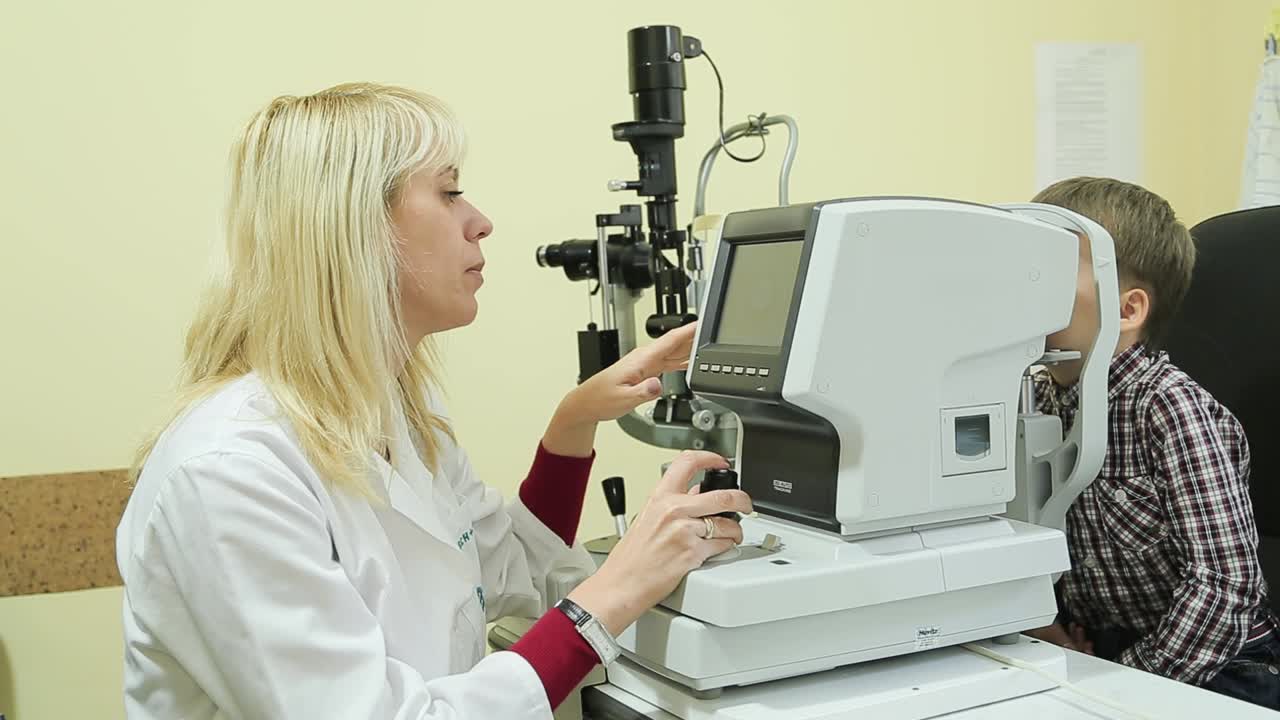 Boy checks eyesight. Medical examination child in clinic