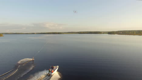 Kitesurf-and-speedboat-running-on-calm-waters-of-river