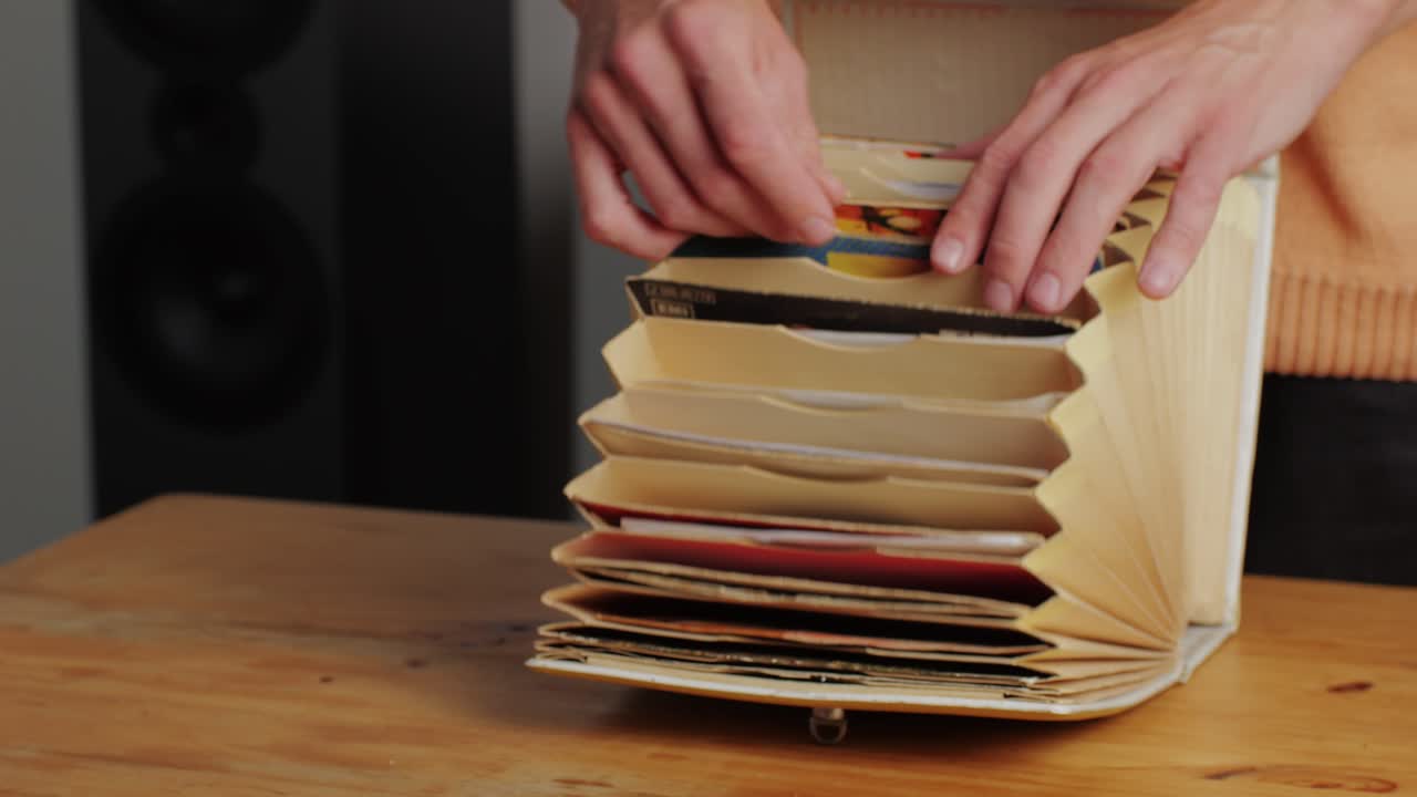 Man hands browsing vintage vinyl records in special bag close-up. Searching music. Musical shopping. Retro Vinyl record player. High quality 4k footage
