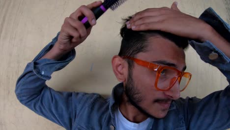 combing-hair-with-brush-man-in-denim-jacket-indian