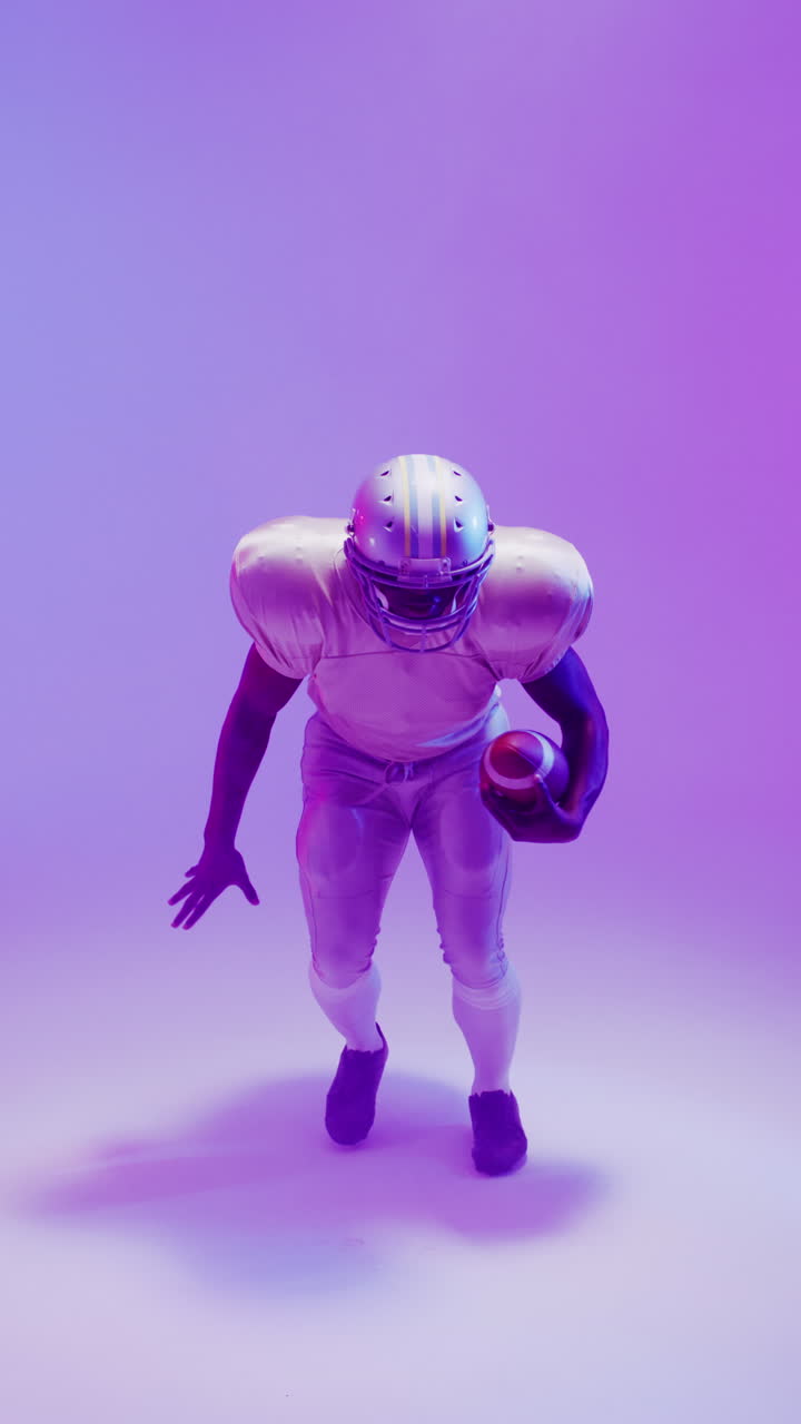 video vertical de un jugador de fútbol americano afroamericano con iluminación púrpura de neón