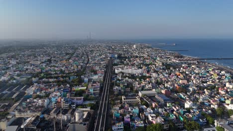 aerial drone shot of metro railway station passing through the city in north chennai