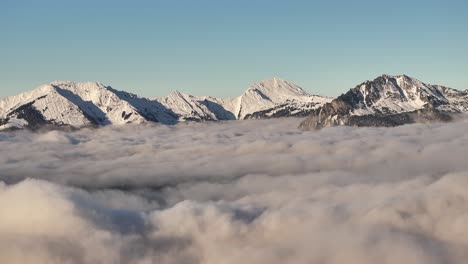 stunning aerial view of snow-capped peaks piercing through a vast sea of fog in glarus nord, switzerland, showcasing the serene beauty of the rautispitz and glärnisch mountains. winter spectacle.