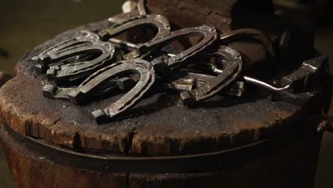 horseshoes on an anvil in a blacksmith shop