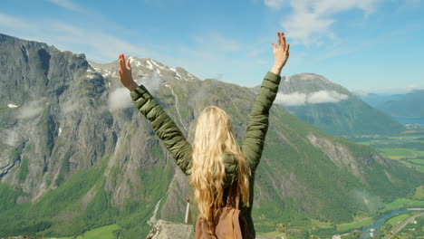 woman enjoying a breathtaking mountain view in norway