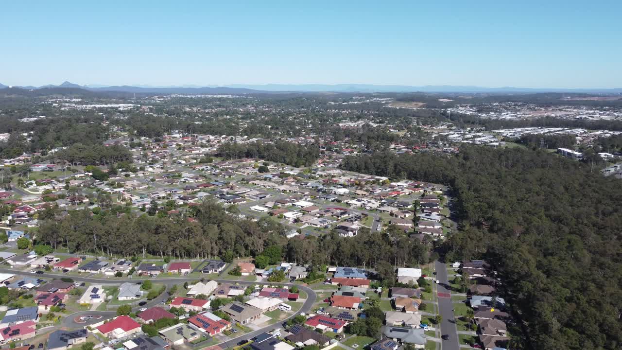 4K Aerial view of a neighbourhood with private homes near a bushland in Australia
