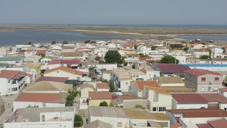 Flying-Over-The-Beach-Houses-In-Armona-Island-On-A-Sunny-Summe-Day-In-Algarve,-Portugal