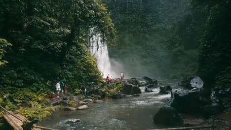 bali, spring 2020 in 1080 60p, daytime, cinematic drone flight long slow motion backward flight from waterfall over the river to a indigenous bridge