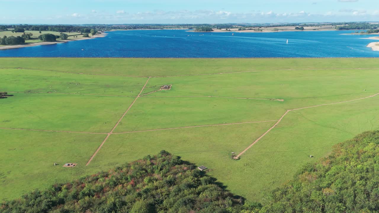 Aerial view of green fields and blue lake near St Peter church village