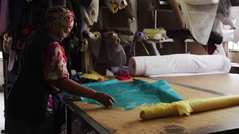 mixed race woman working at a hat factory