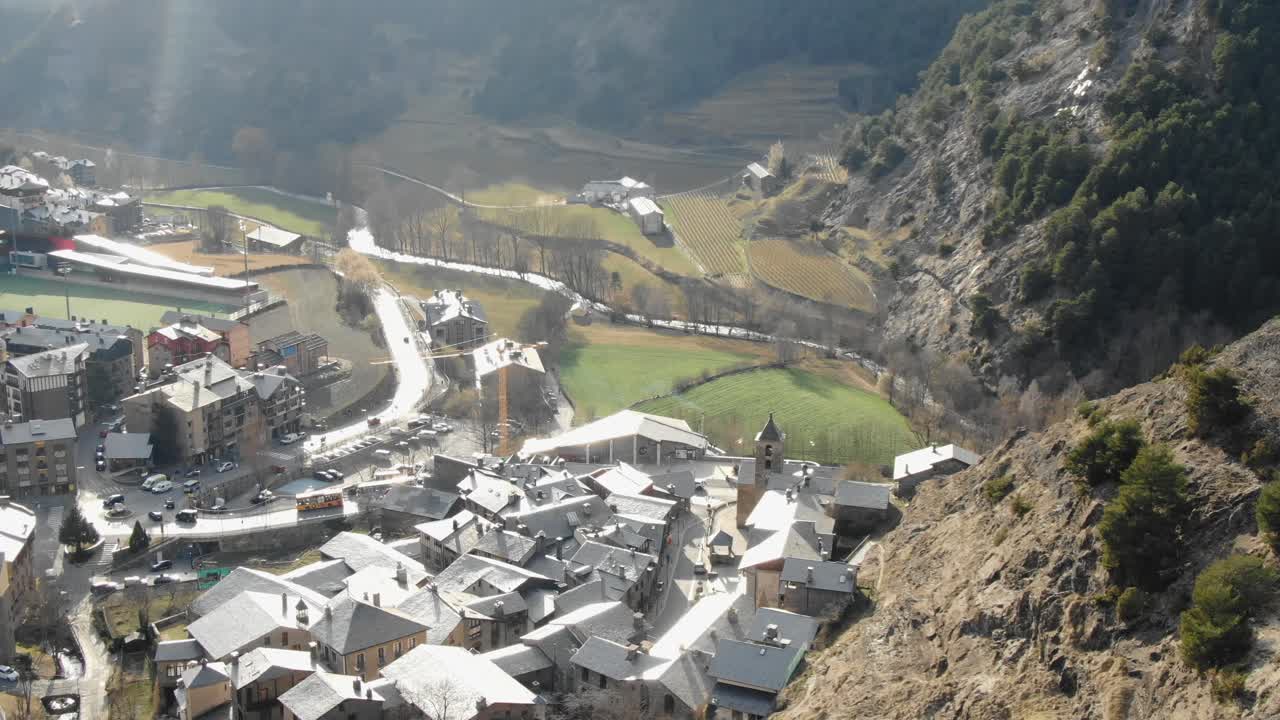 Aerial view overlooking Andorran village nestled in sunlit mountain valley. Picturesque Pyrenees, charming European town, travel destination