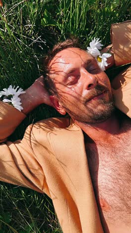 man relaxing in a field with flowers