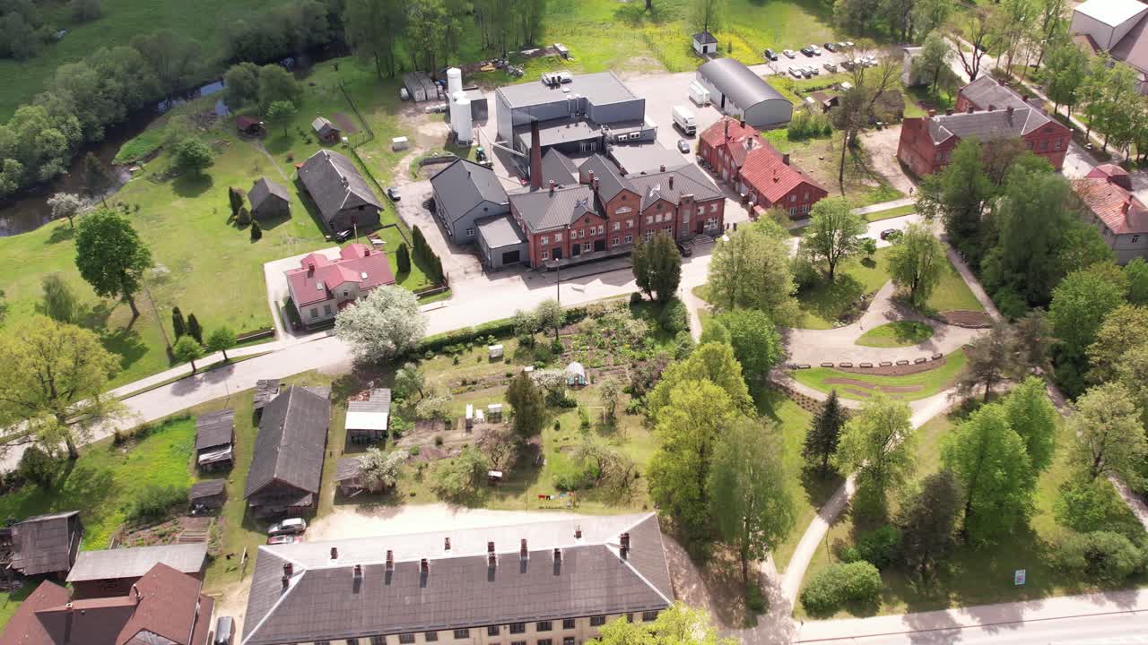 Aerial View of a Picturesque Village with Historical Buildings and Lush Greenery