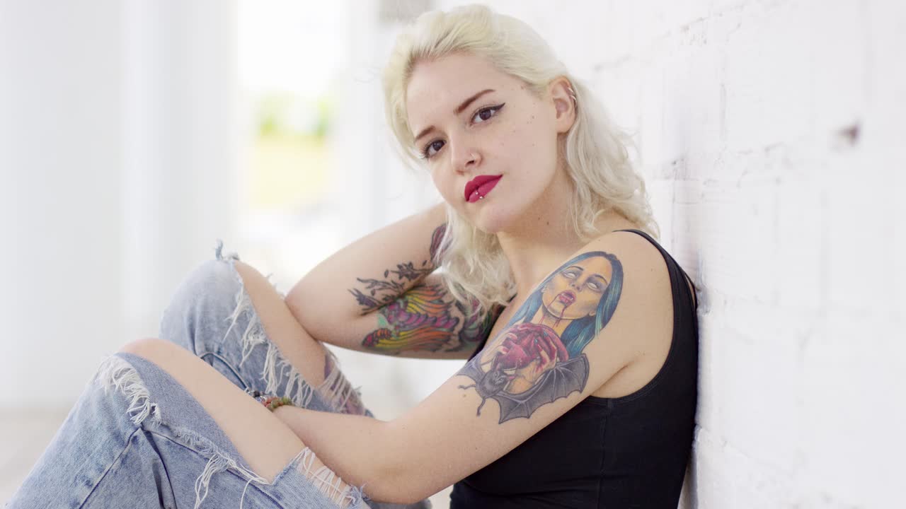 Sexy sultry young woman with a vampire tattoo