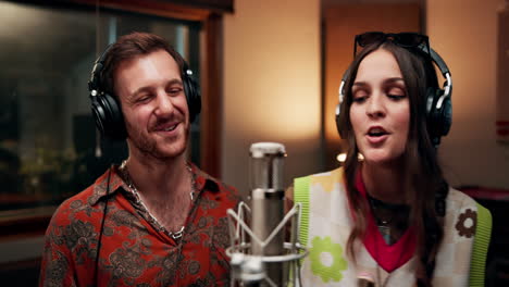 singers recording a duet in a music studio
