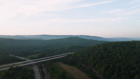 aerial view of vehicles traveling on highway bridge near lake fort smith in arkansas, usa - drone shot