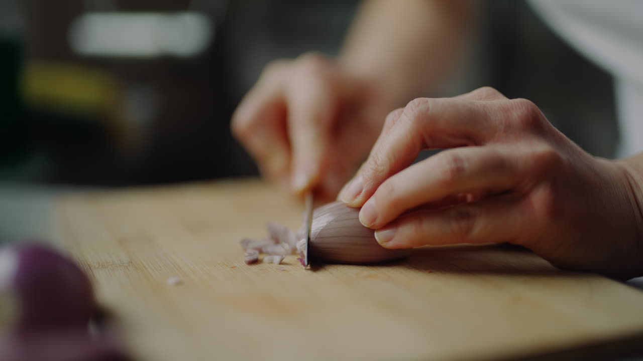 Close-Up Of Slicing Onion Shallots In Kitchen Preparing Food Cooking Peeling Vegetables