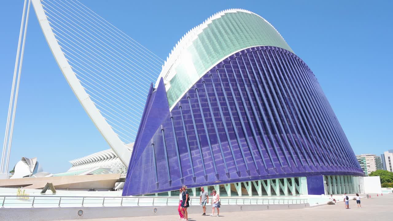 Visitors walk outside the CaixaForum Valencia, Agora, in the City of Arts and Sciences. Designed by Santiago Calatrava, it is the most significant modern tourist destination in Valencia.