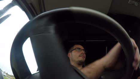 In-cab-action-cam-view-of-a-male-HGV-Driver-maneuvering-a-articulated-lorry-around-a-roundabout